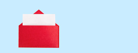 Banner red open envelope with a sheet of paper with mock up on a blue background with copyspace. Valentine's day holidays concept and love notesの写真素材