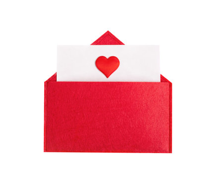 Red open envelope with a sheet of paper with a heart on a isolated background with copyspace. Valentine's day holidays concept and love notes, christmas and new year letters for Santa Clausの写真素材