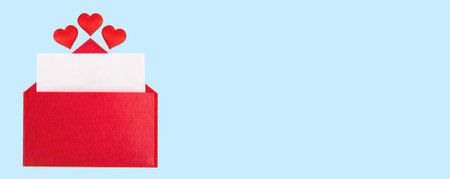 Banner red open envelope with a sheet of paper with a hearts on a blue background with mock-up. Valentine's day holidays concept and love notesの写真素材