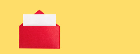 Banner red open envelope with a sheet of paper with mock up on a yellow background with copyspace. Valentines day holidays concept and love notesの写真素材