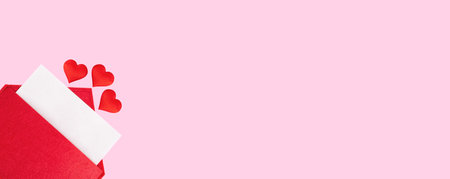 Banner red open envelope with a sheet of paper with a hearts on a pink background with mock-up. Valentines day holidays concept and love notes, christmas and new year letters for Santa Claus.の写真素材