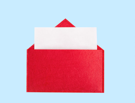 Red open envelope with a sheet of paper with mock-up on a blue background with copyspace. Valentines day holidays concept and love notes.の写真素材