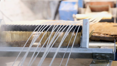 Recycled molten plastic comes out of the extruder machine Concept of recycling, plastic, industry,...