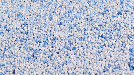 Secondary granule made of polypropylene, Blue Plastic pellets crumbles to the table. Plastic raw materials in granules for industry. Polymer resin. Raw plastic recycling conceptの写真素材
