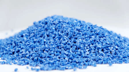 Secondary granule made of polypropylene, Blue Plastic pellets crumbles to the table. Plastic raw materials in granules for industry. Polymer resin. Raw plastic recycling conceptの写真素材