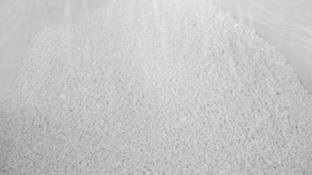 White hard grinded plastic comes out of the cyclone of the machine by pneumatic transport into the big bag. concept of recyclable materials, plastic recycling, pellet production plantsの写真素材