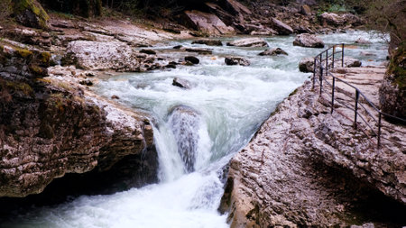 Amazing waterfall Falling water hitting water surface some huge rocks with an observation area. The concept of travel, outdoor activities, adventure, tourism, vacation.の写真素材