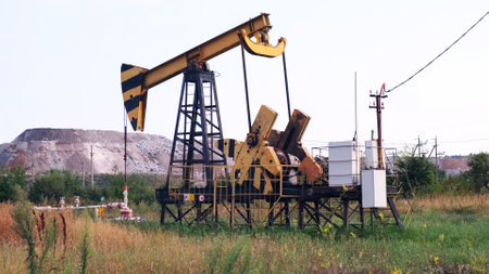 Industrial oil production industry, derrick pumps oil outdoors in the field on the oil platform. The concept of the economy, production and extraction of oil, environmental pollution, fuel, petroleumの写真素材