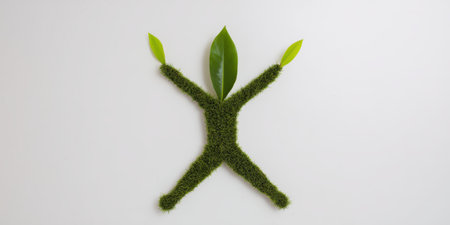 Grass and leaves forming a human shape, conceptualizing eco-friendly living, sustainability, and the harmony between humanity and nature against a clean white backgroundの素材