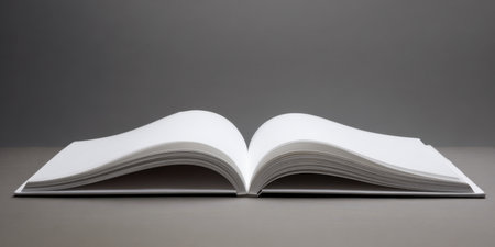 Open book displaying empty white pages, representing concepts of learning, knowledge, storytelling, design, and new beginnings on a monochromatic gray backgroundの素材