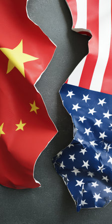 China and usa flags tearing apart, creatively representing geopolitical conflict, trade war, broken relationships, and political disagreements between the two global powers on a dark backgroundの素材