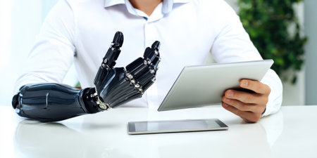 Man with a sophisticated bionic prosthetic arm interacting with a digital tablet while another tablet rests on a white table, representing advanced technology, innovation, and future accessibilityの素材