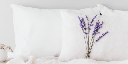 Fresh lavender flowers lie arranged on cozy white bed linen, creating a serene atmosphere and symbolizing relaxation, sleep, aromatherapy, and natural home comfortの素材