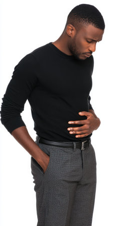 African american man experiencing discomfort and holding his stomach, depicting concepts of stomach ache, indigestion, pain, and health issues on a clean white backgroundの素材