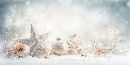 Christmas star ornament and festive baubles resting on white snow with glowing bokeh lights in background, creating a serene winter holiday atmosphereの素材