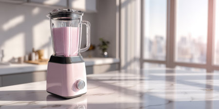 Countertop blender filled with a healthy pink smoothie, sitting on a marble kitchen island with bright sunshine streaming through a large window overlooking a cityの素材