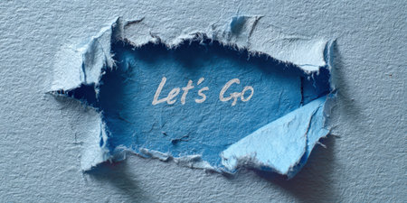 Blue textured paper with a central rip revealing a darker blue layer underneath displaying the handwritten message let's go, symbolizing new beginnings and pushing forwardの素材
