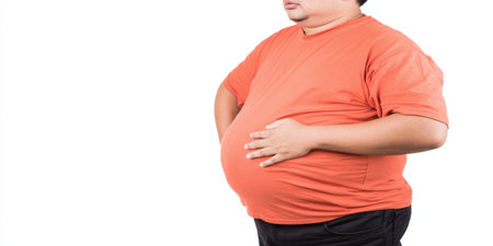 Overweight man standing with hands on his large belly, symbolizing health problems, an unhealthy lifestyle, extra fat, and the need for diet or weight loss isolated on a white backgroundの素材