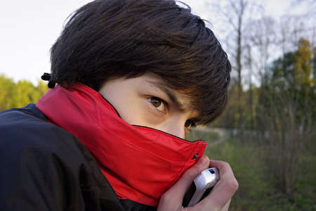 The teenager hides the face in a collarの写真素材