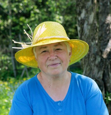 Smiling woman in yellow hat の写真素材