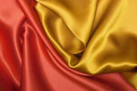 Elegant and soft red and yellow satin background. の写真素材