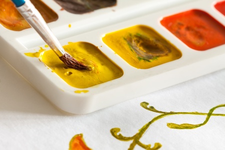 Sketch of flower and watercolors with brush.の写真素材