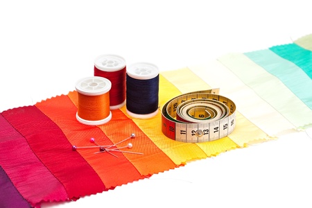 Bobbins of thread and tape measure on light background.の写真素材