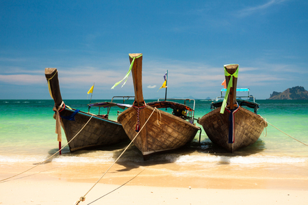 Tropical blue sea with boats and yellow beach.の写真素材