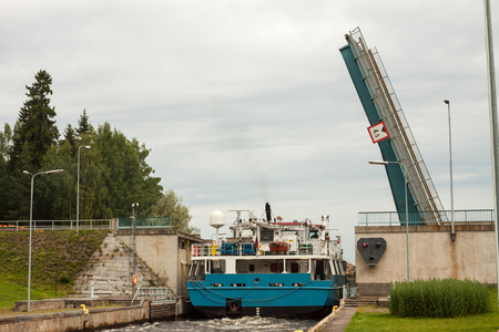 Barge with wood passes through a sluice in Finland.の写真素材