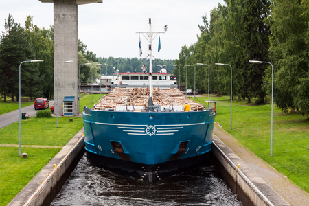 Barge with wood passes through a sluice in Finland.の写真素材