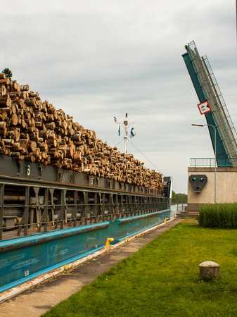 Barge with wood passes through a sluice in Finland.の写真素材