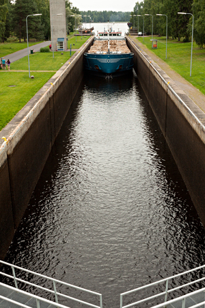 Barge with wood passes through a sluice in Finland.の写真素材