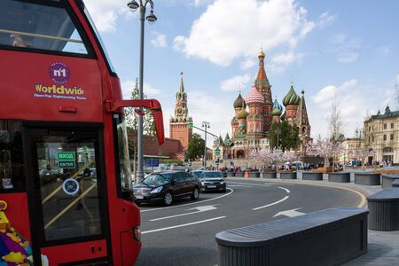 MOSCOW, RUSSIA - MAY 17, 2018: red Double-Decker sightseeing bus near St. Basil's (Pokrovsky) Cathedral and Spasskaya tower.のeditorial素材