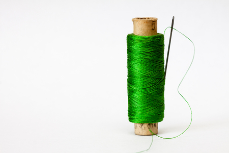 Old coil of green thread isolated on a white background.の写真素材