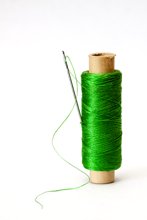 Old coil of green thread isolated on a white background.の写真素材