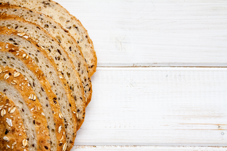 Top view of bread with different seeds on old wooden background.の写真素材