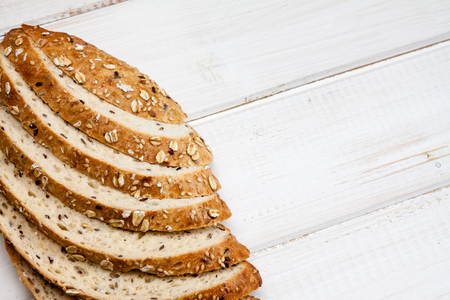Top view of bread with different seeds on old wooden background.の写真素材