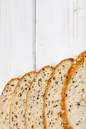 Top view of bread with different seeds on old wooden background.の写真素材
