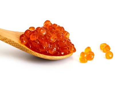 Red caviar in the wooden spoon isolated on a white background.の写真素材