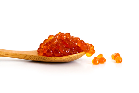 Red caviar in the wooden spoon isolated on a white background.の写真素材