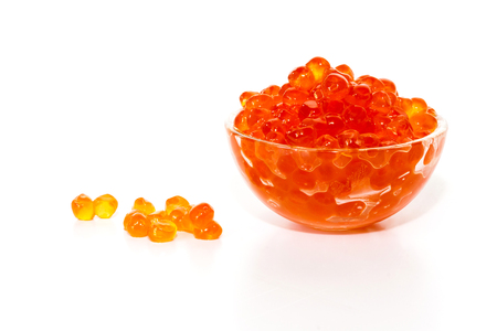 Red caviar in the glass bowl isolated on a white background.の写真素材