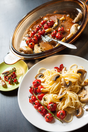 Spaghetti pasta with cherry tomatoes, mushroom, pepper and garlic.の写真素材