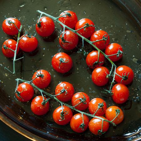 Cherry tomatoes for cooked with olive oil, salt and pepper.の写真素材