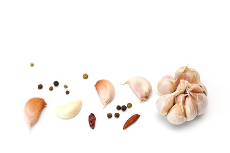 Raw garlic segments, pepper and red chillies isolated on white background.の写真素材