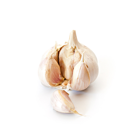 Raw garlic with segments isolated on white background.の写真素材