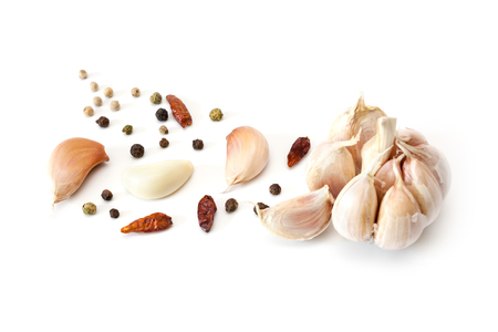 Raw garlic segments, pepper and red chillies isolated on white background.の写真素材