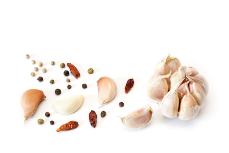 Raw garlic segments, pepper and red chillies isolated on white background.の写真素材