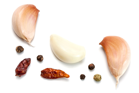 Raw garlic segments, pepper and red chillies isolated on white background.の写真素材