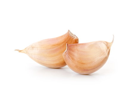 Raw garlic segments on a white background.の写真素材