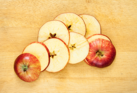 Slices of apple on a wood background.の写真素材